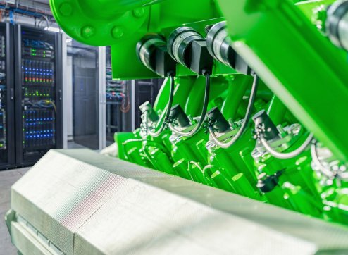 Ein Fachmann überprüft den generalüberholten Gasmotor in einem Data Center von PowerUP.