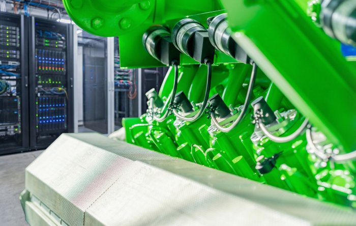 Ein Fachmann überprüft den generalüberholten Gasmotor in einem Data Center von PowerUP.